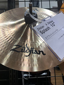 Image of a Zildjian drum cymbal in a music shop.